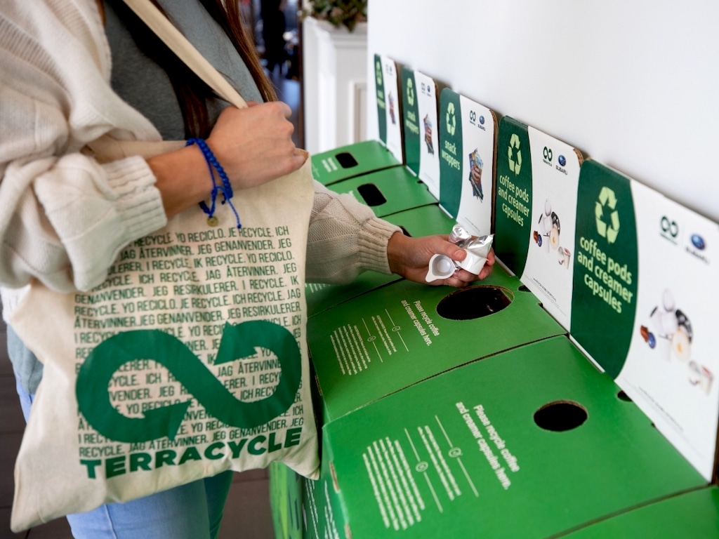 Consumer recycling coffee pods at a Terracycle collection station